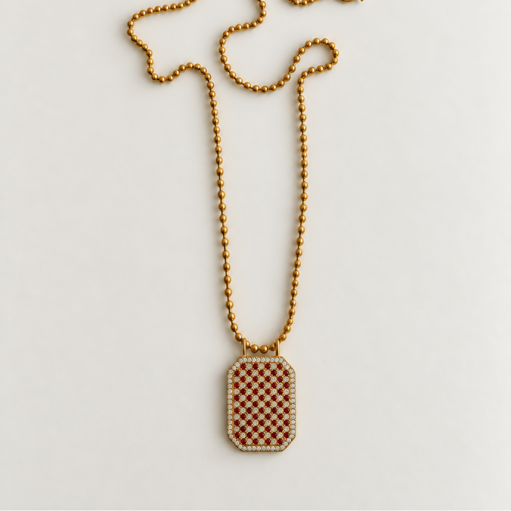 A gold-tone beaded chain necklace with a rectangular pendant featuring a brown and white checkered pattern, bordered with small clear stones, displayed on a light gray background.